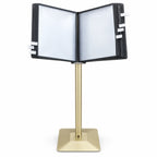 Gold floor-standing flip display stand with black-framed document pockets open for browsing and index tabs along the sides.